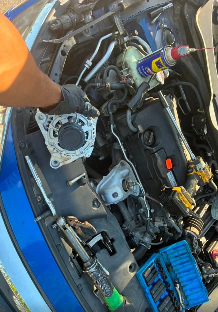 Mobile mechanic installing a replacement alternator during on-site auto repair service in Fort Worth TX